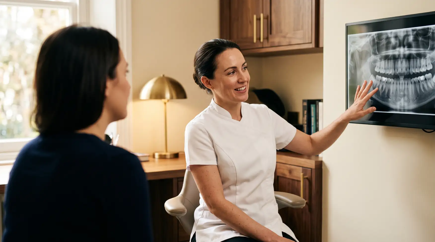 Dr. Curmaku reviewing a dental implant scan during a consultation